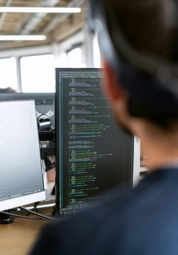 pexels-photo-3861959-3861959 A male software engineer working on code in a modern office setting.